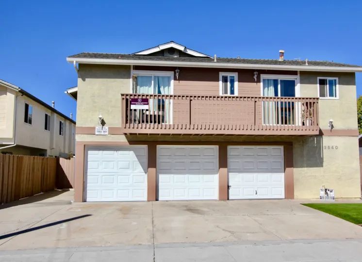 Three white garage doors at Madison Gardens located at Normal Heights CA
