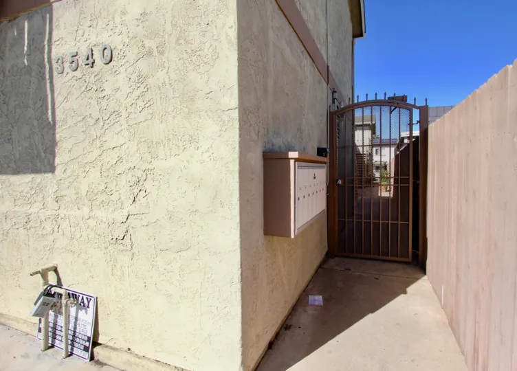 A sunny day in the area of Madison Gardens, gate, mailboxes, outside, fence