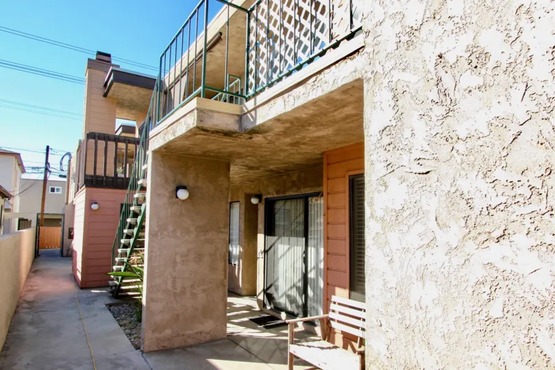 Clear, blue skies over the front entrances and patio areas of Magnolia Manor apartment complex in Normal Heights, California