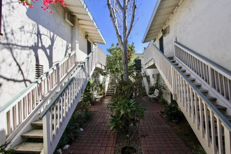 Colourful flowers and trees in between villas with stair case in Mission Villas II of Normal Heights