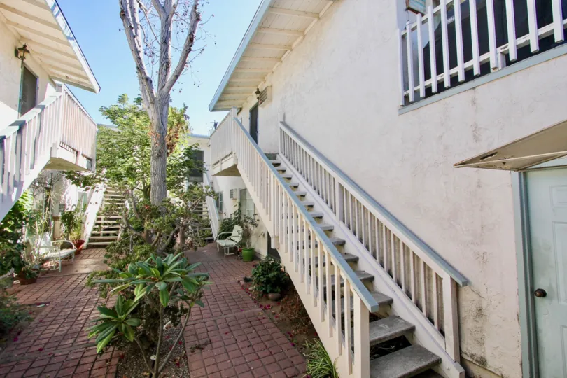 A sunny day in Mission Villas II with staires in the house