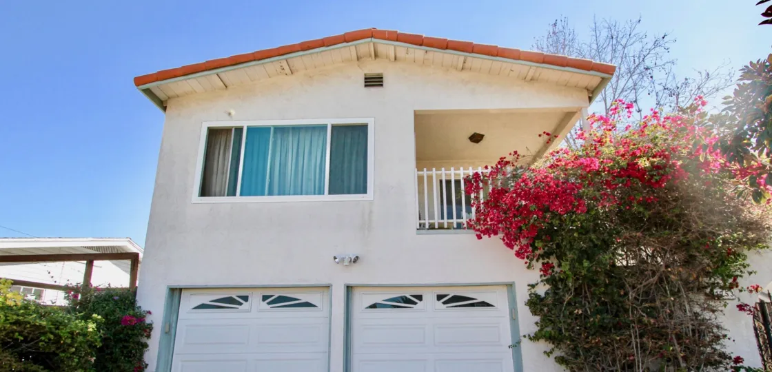A sunny day in the area of Mission Villas II, outside, garage, flowers, balcony, condo