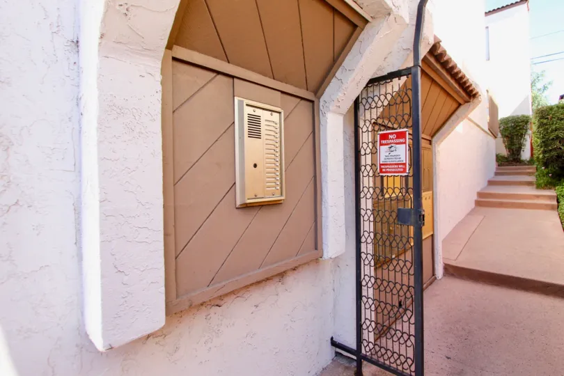 Entrance to Mission Villas with metal gate and call box to apartments in Normal Heights, Ca.