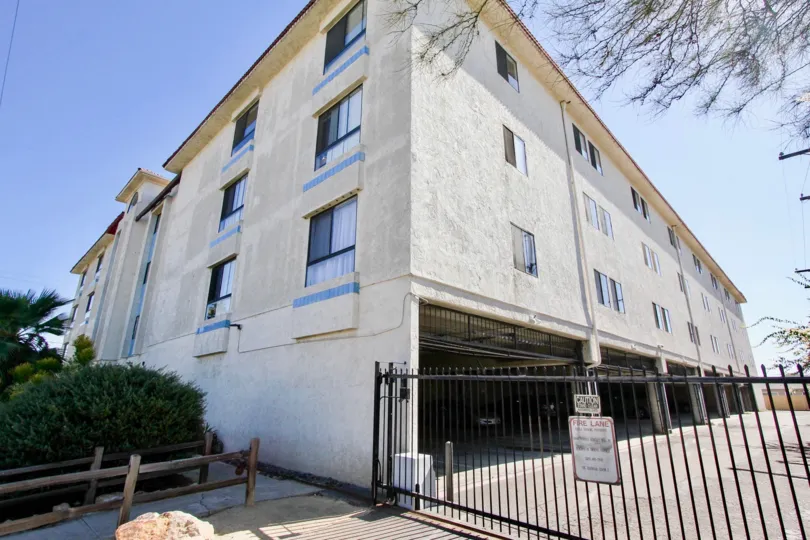 A side view of a fenced-off Monroe Manor housing complex, in Normal Heights, CA.