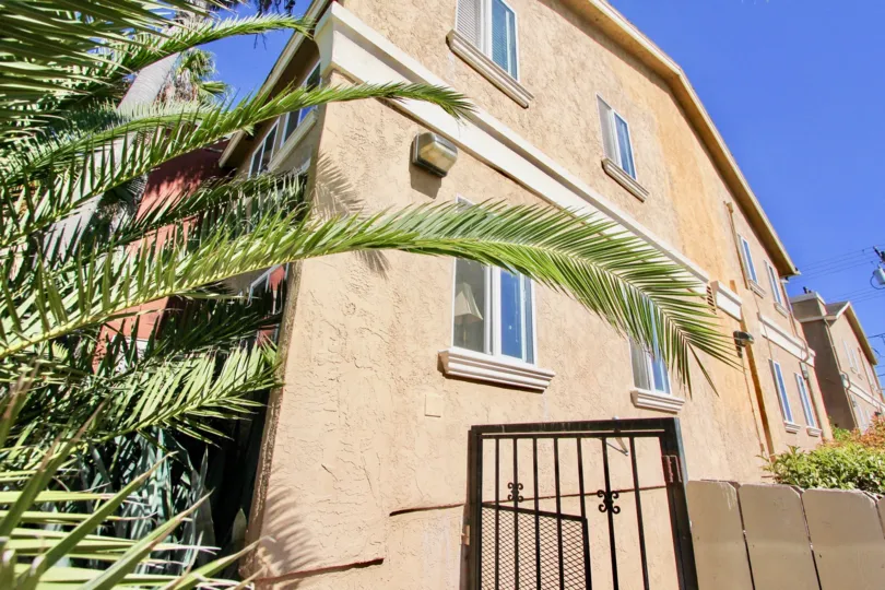 A WARM DAY IN THE MONROE VILLAS II WITH A HOUSE THAT HAS GATE AT ITS SIDE