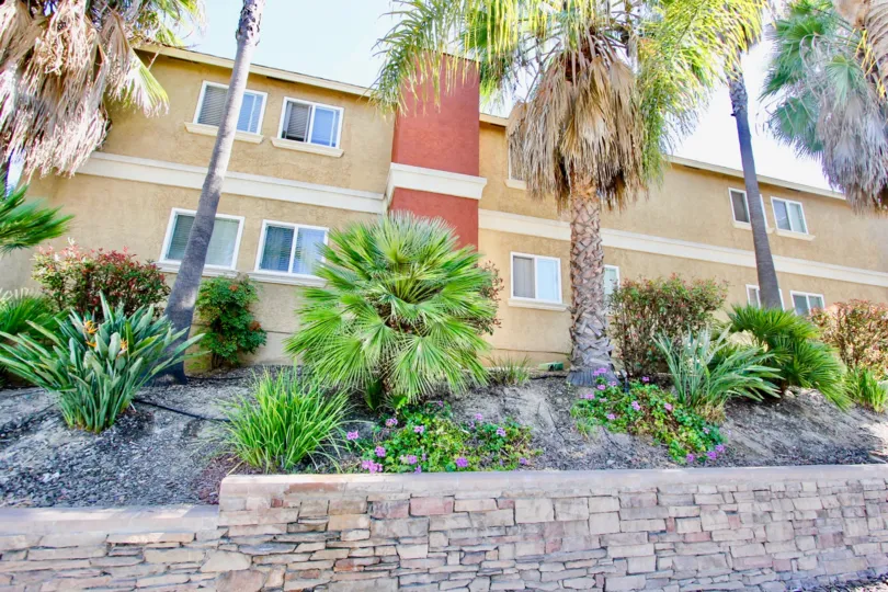 Brick sidewalk and landscaping on a hill in front of Monroe Villas II, Normal Heights, California