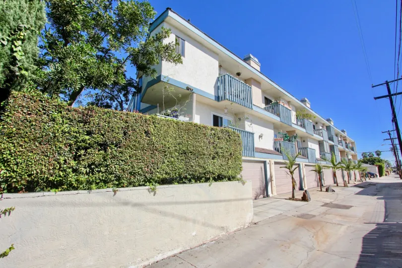 THE APARTMENT IN THE MOUNTAIN VIEW VILLAS WITH THE POST WIRES, PLANTS, TREES, BALCONIS