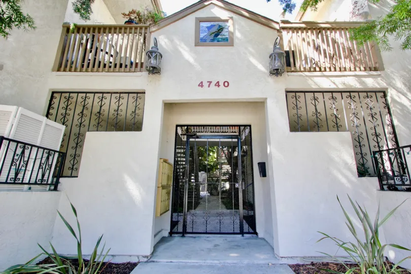 A black iron security door in front of the Normal Heights Villas at Normal Heights CA