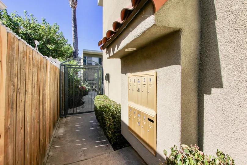 Pathway to the house has postal boxes with bushes and plants