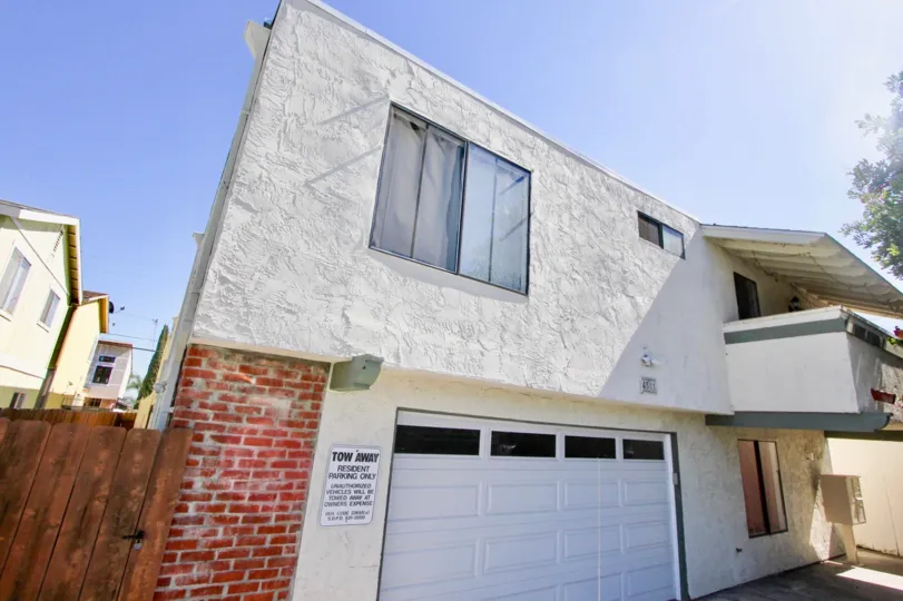 A Sunny day with a white house and garage in Oaktree Villas