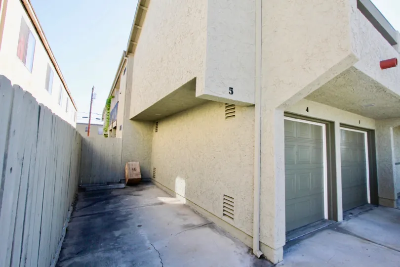 a view of the back enterance, a little dirty, clean looking building on side