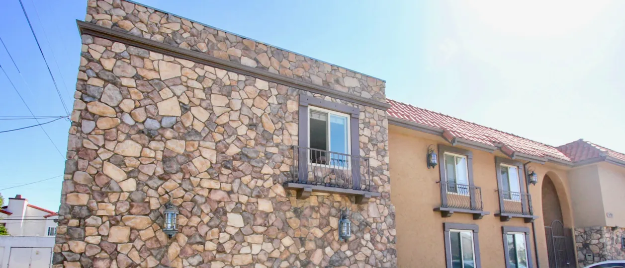 A front view of a stone tiled orange house on 34th in Normal Heights.