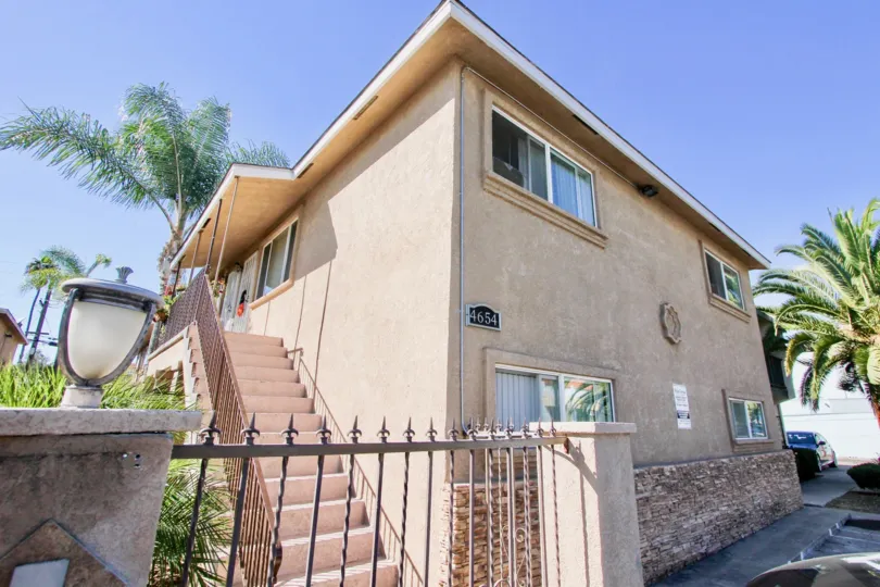 A sunny day in the area of Palm Terrace, outside, fence, light, condo. palm trees, sidewalk