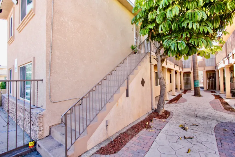 Side staircase going up to apartments running alongside a courtyard in Normal Heights in California.