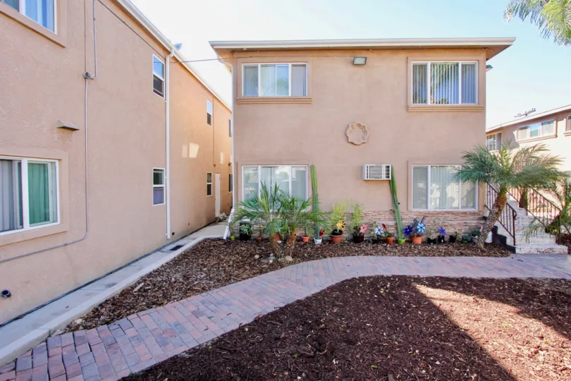 A sunny day in the Palm Terrace community Normal Heights, CA showing rear dwelling and potted plants