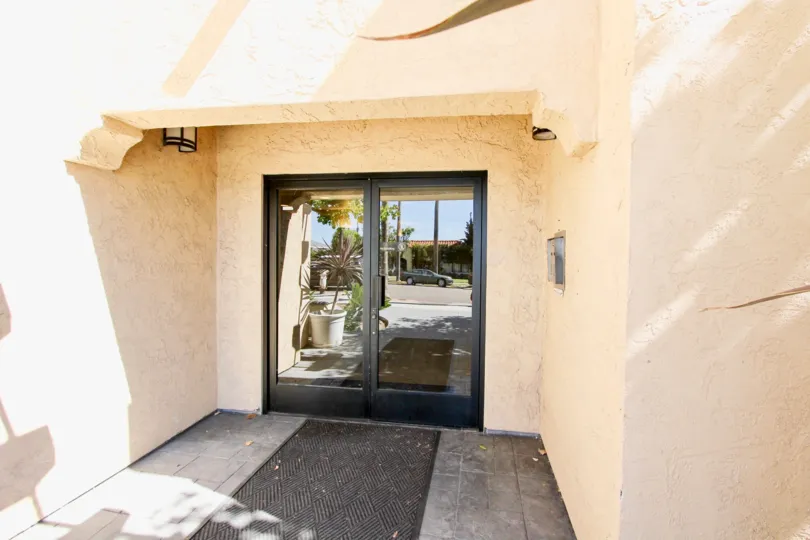 The sunny reflection of the street in the entrance to Plaza Arizona in Normal Heights, California.