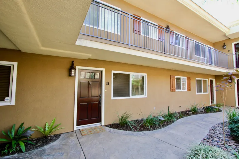 A sunny day in the area of Stone Manor, sidewalk, condo, balcony, ferns