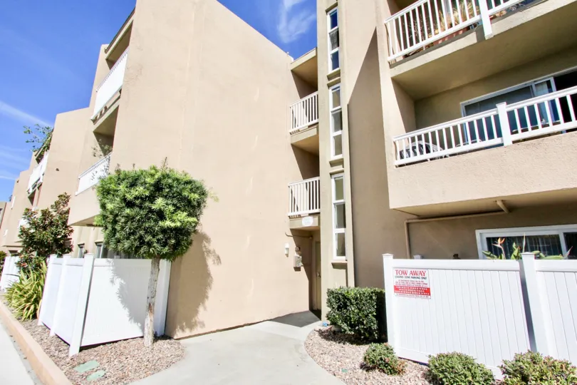 A cream colored building in a sunny setting in Suncreast Villas neighborhood.