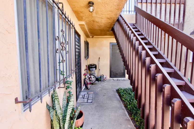 THE ESTATE IN THE TERALTA HEIGHTS WITH THE UPSTAIRS, BICYCLE, FLOWER POT, PLANTS