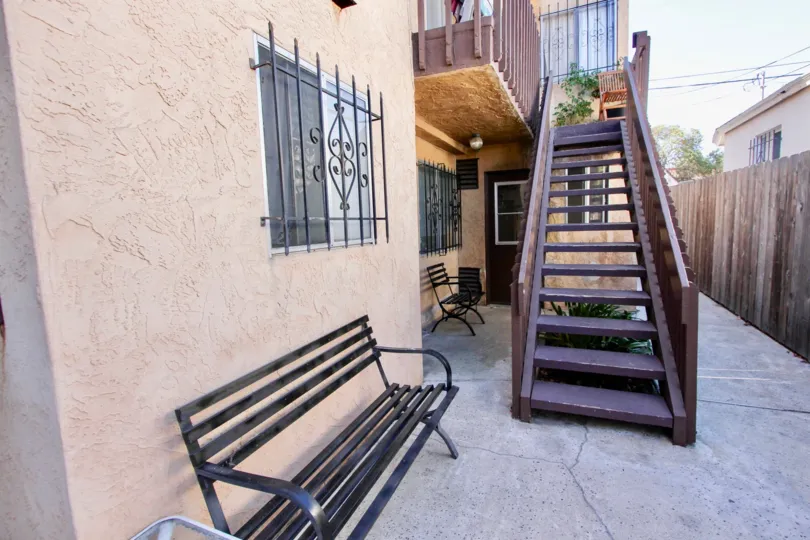 A sunny day in the area of Teralta Heights, outside, bench, stairs, wooden fencem windows, door