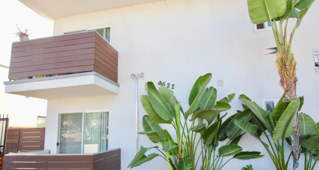 A sunny day in the area of Utah Bluffs, outside, plants, tree, balconies, sliding glass door