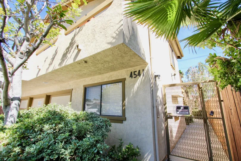 Sunny day corner side view of residence with side gate in Utah Terrace, Normal Heights, CA