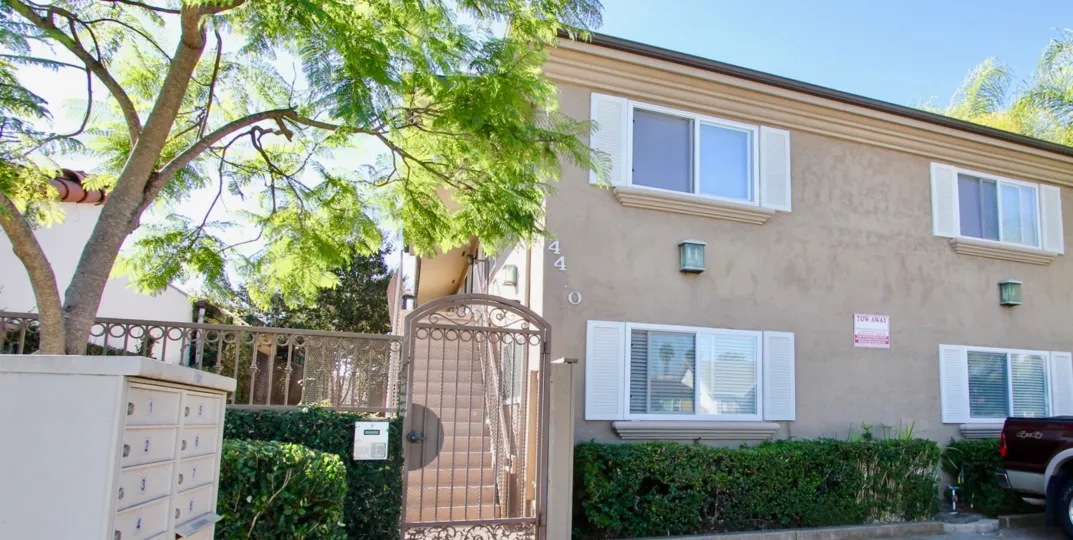 A sunny day in the area of Utah West Villas, gated entrance, mailboxes, truck, window, stairs, parking lot
