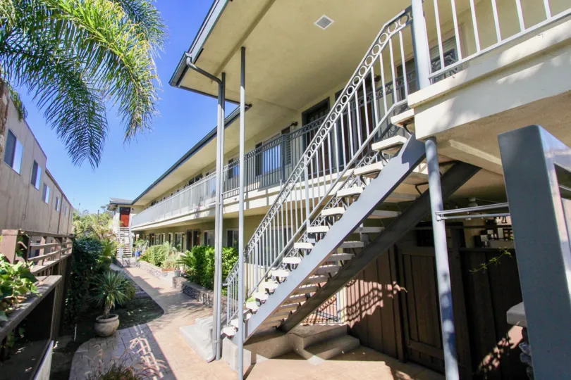 Outdoor stairs and balcony of an apartment complex in the West Mountain View Condos area of Normal Heights, California