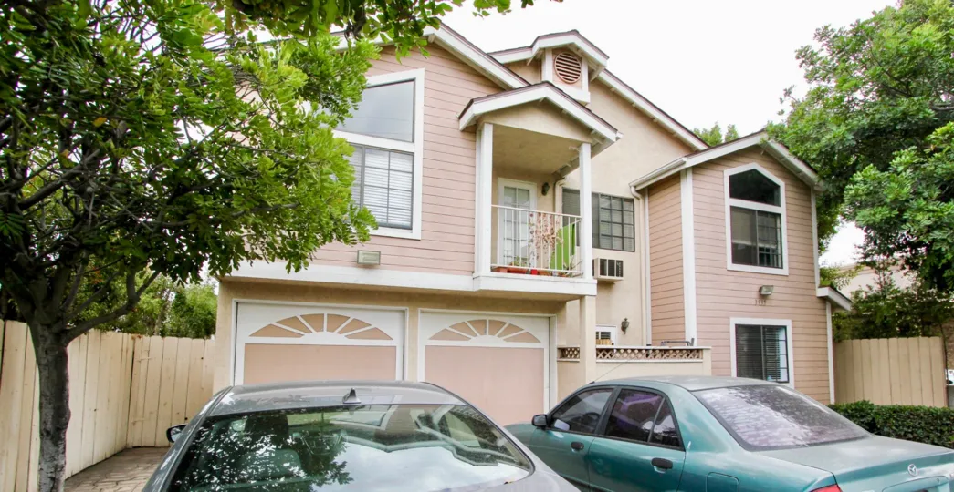 A sunny day in the area of 32nd Street Condos, trees, building, cars, garage