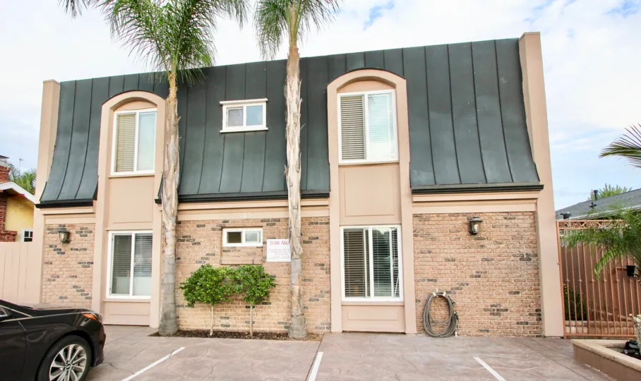 A sunny day in the area of 3345 29th Street, condos, driveway, car, palm trees