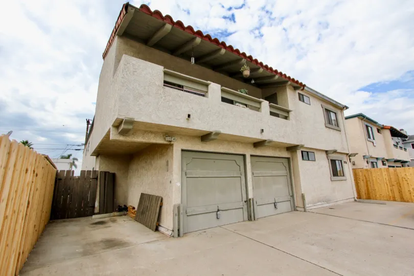 A two story home with a two car garage and a balcony on the second floor in the 33rd Street Vistas community of North Park, California