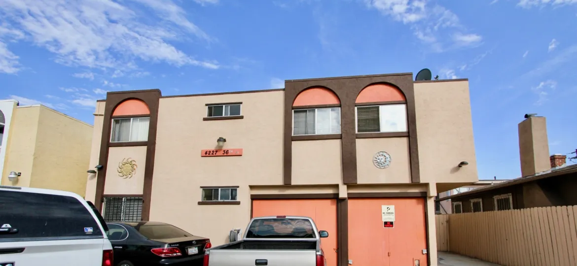 A sunny day in the area of 36th Street Condos, parking area, car, truck