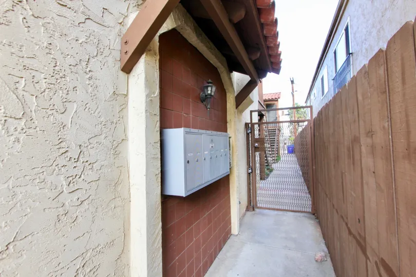 Walkway between buildings with metal gate at 36th Street Villas
