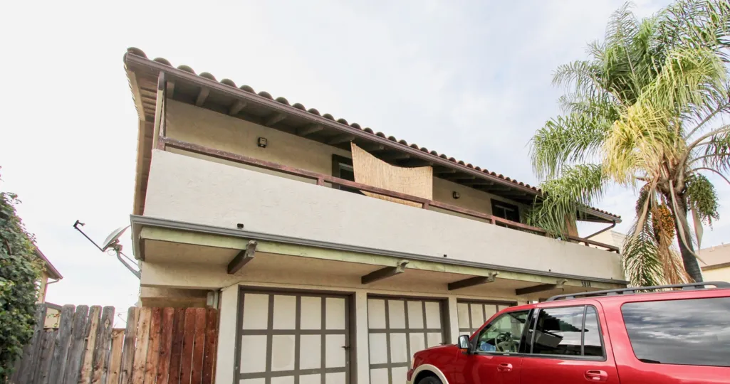 Wide balcony with wooden fence and parking in 3814 35th St.