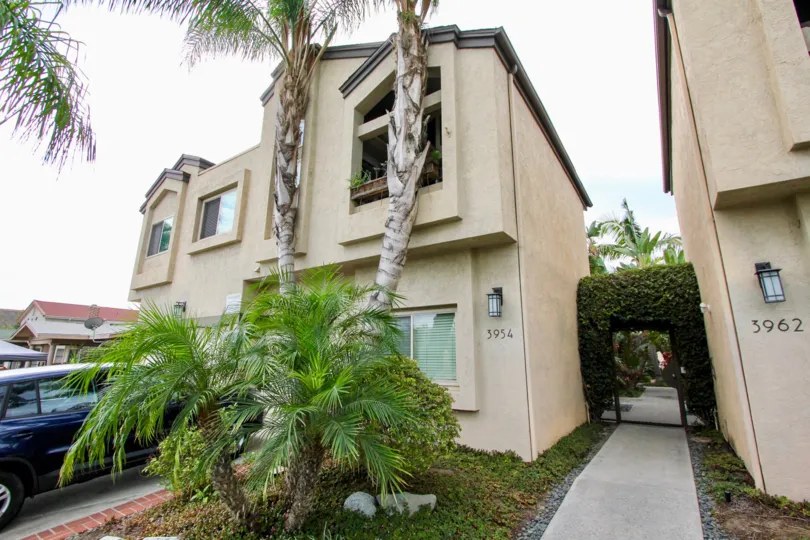 Front of house with beautiful flowers in front yard and little tree in the 3788 Grim Ave