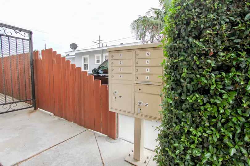 Wooden fencing with letter boxes and greens in 4111 Iowa St.