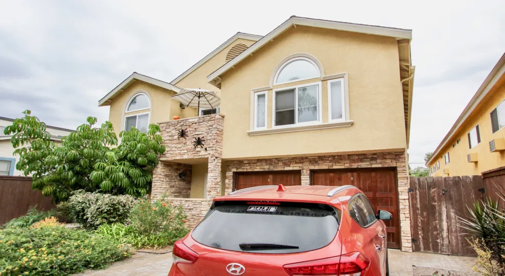 A red Toyota is parked in a driveway of a home at 4133 Florida St.
