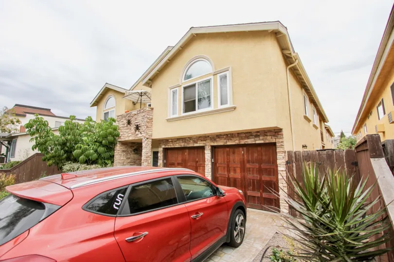 Housing with attached garage with wooden doors at 4133 Florida St in North Park California