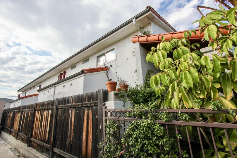 A sunny afternoon in the area of 4166 Wilson Ave, fence, gate, apartment