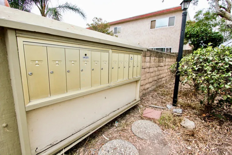 The mailboxes along a brick wall in the Alabama 12 community in North Park, California