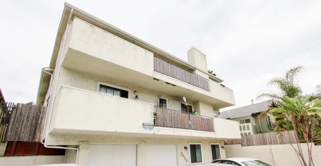 A two story pueblo style residence with private parking and a two car garage