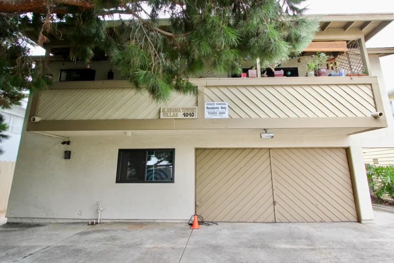 Tan 2 Story House with large balcony and double car carage.  Cement driveway for parking also.  Located in Alabama Villas in North Park, CA