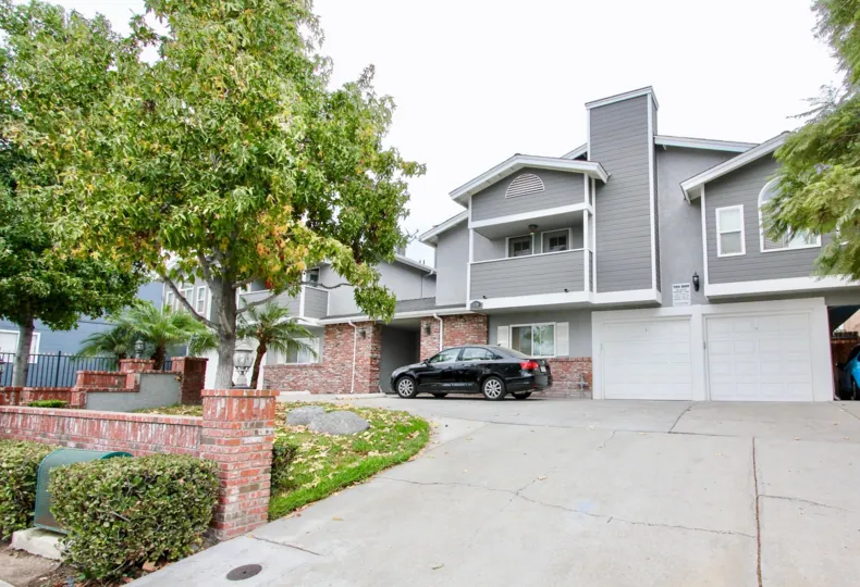 A two story Arizona Gardens home with drive-up parking and detailed landscaping