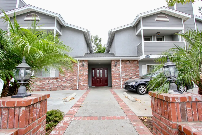 A decorative red door invites visitors to Arizona Gardens condos