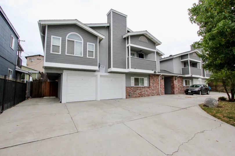 Housing with attached garages and a driveway at Arizon Gardens in North Park California