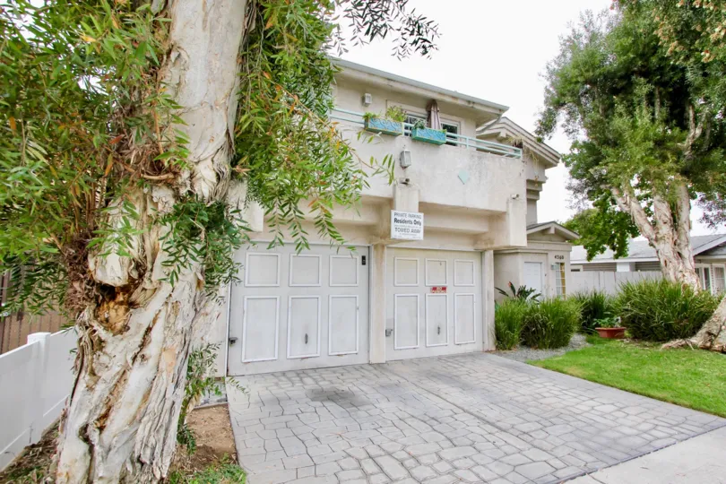 Two stone driveways sit in front of decorative garage doors at the Aspen Ridge homes