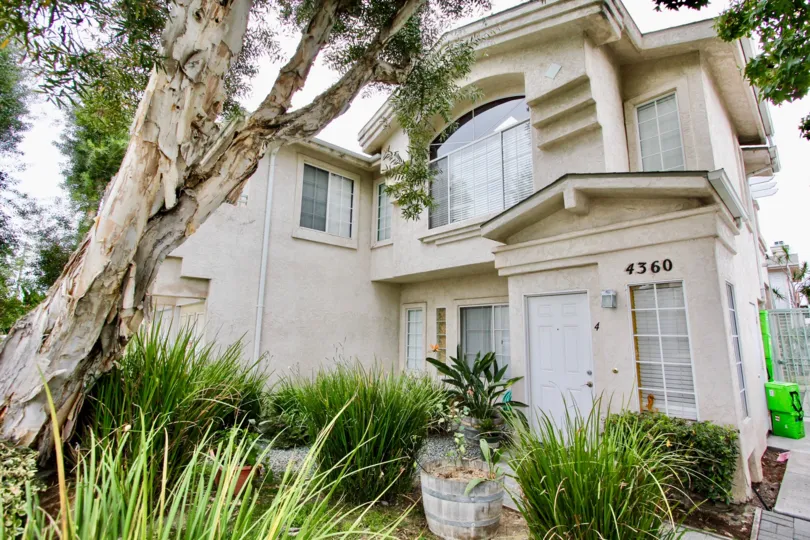 The Exterior view of Aspen Ridge with the sidewalk and front garden