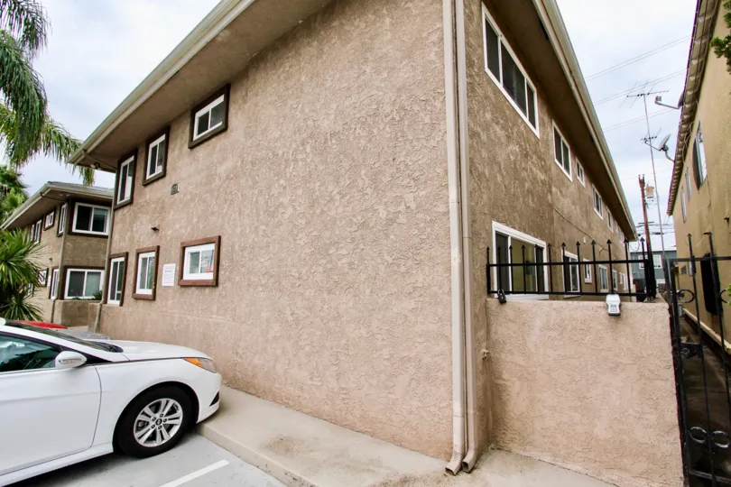 A white car sits in a parking space at the Beacon Point condos.