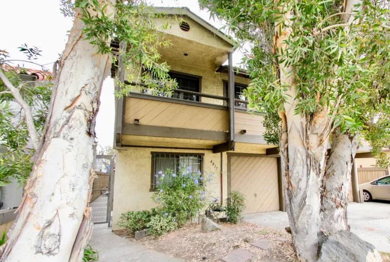 Two story housing with large trees and attached garages at Birchmore in North Park California