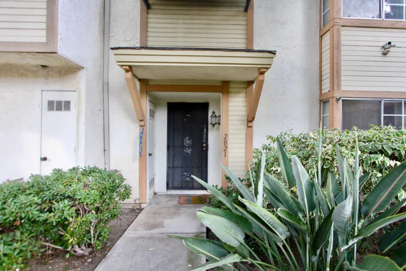 A lush garden walkway leads up to this ground floor unit in California Village.
